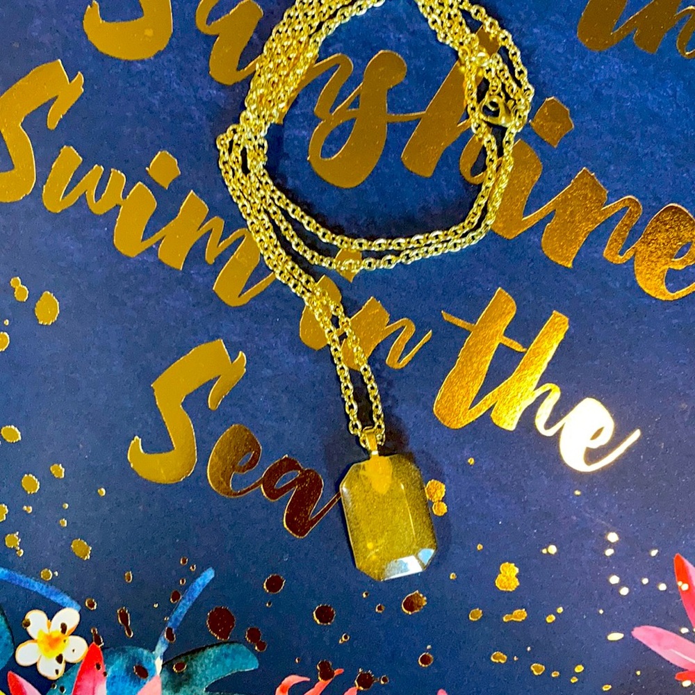 30” handmade goldtone necklace.  Opaque yellow shimmery resin pendant.